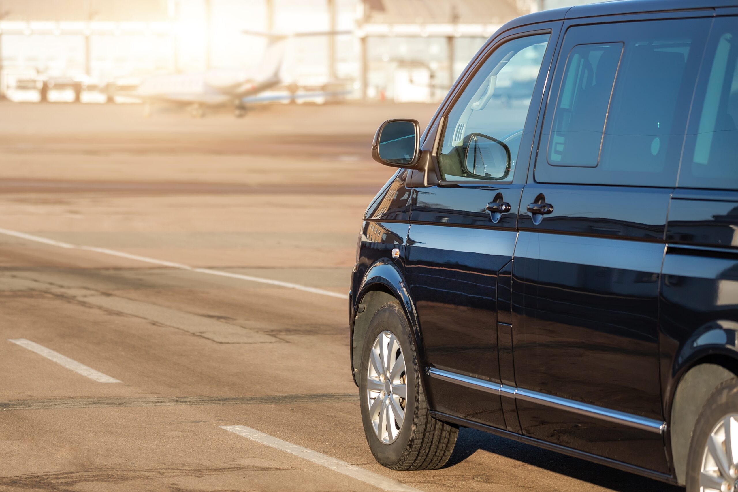 Side,Back,View,Of,Black,Vip,Service,Van,Running,On