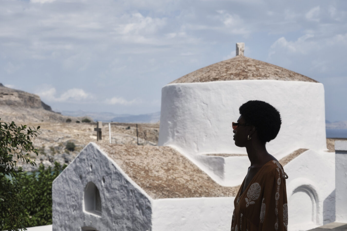 Female guest taking in the views at Lindos settlement, one of the nicest Rhodes villages to visit.