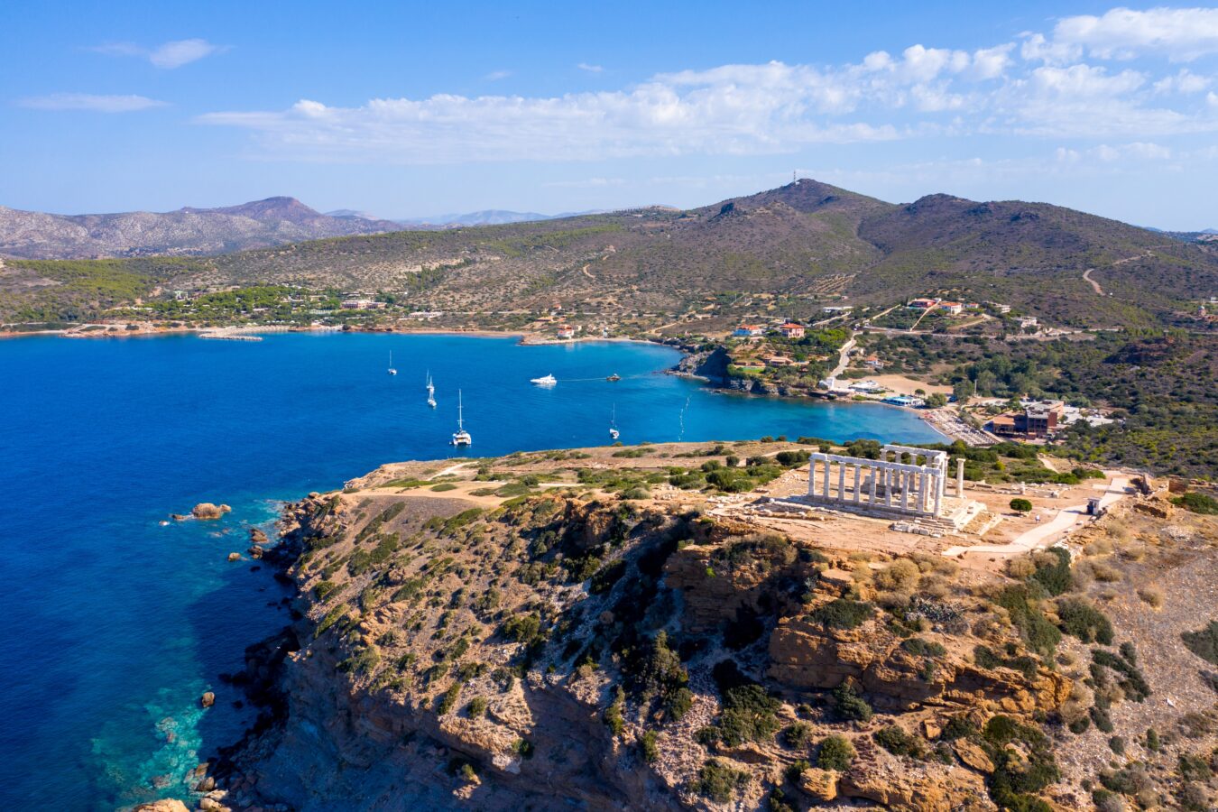 Aerial view of the Temple of Poseidon perched on the cliffs of Cape Sounion, a highlight for summer day trips from Athens.