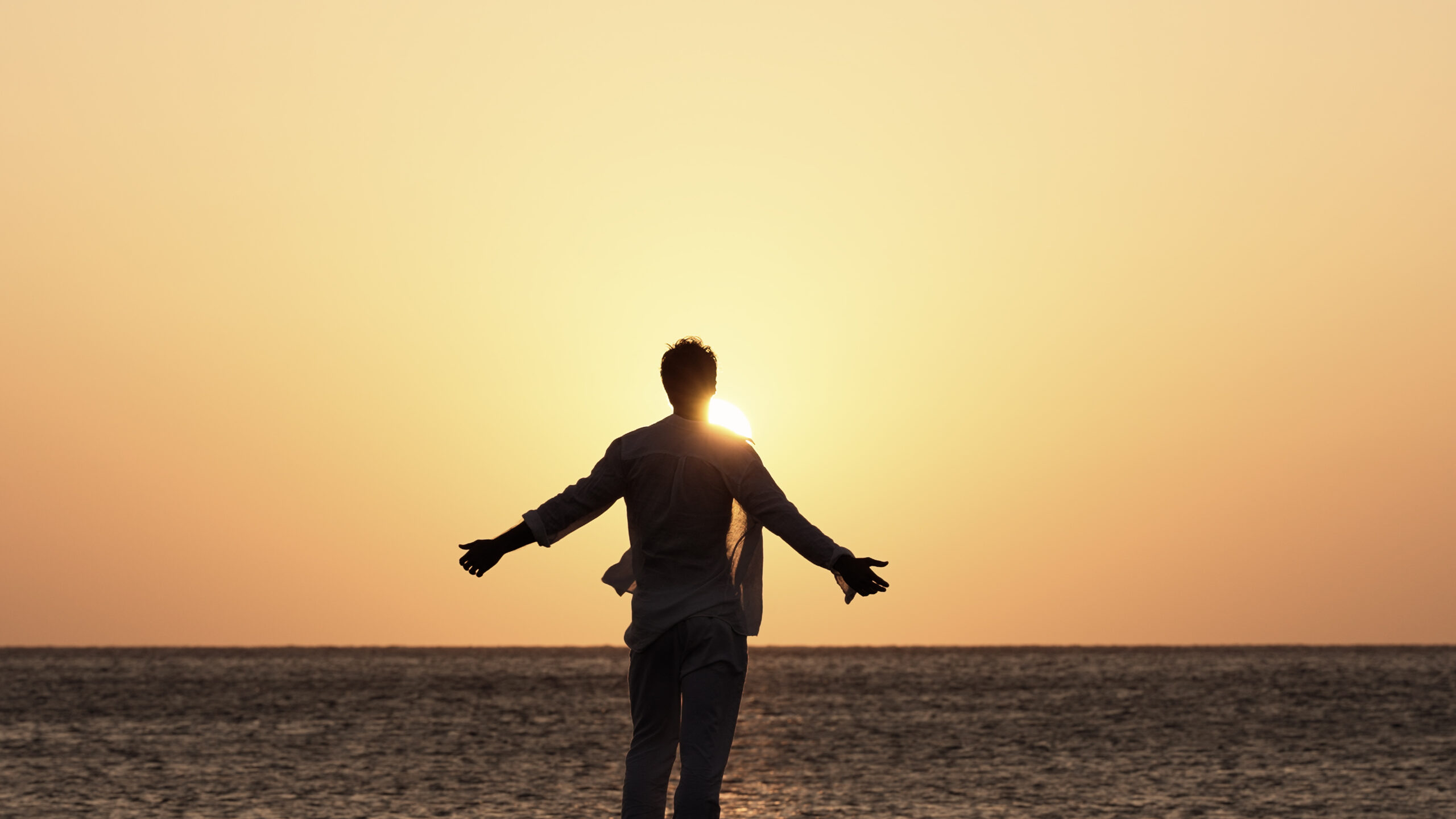 the light we call home, Aegean, a man standing in the beach and the sun