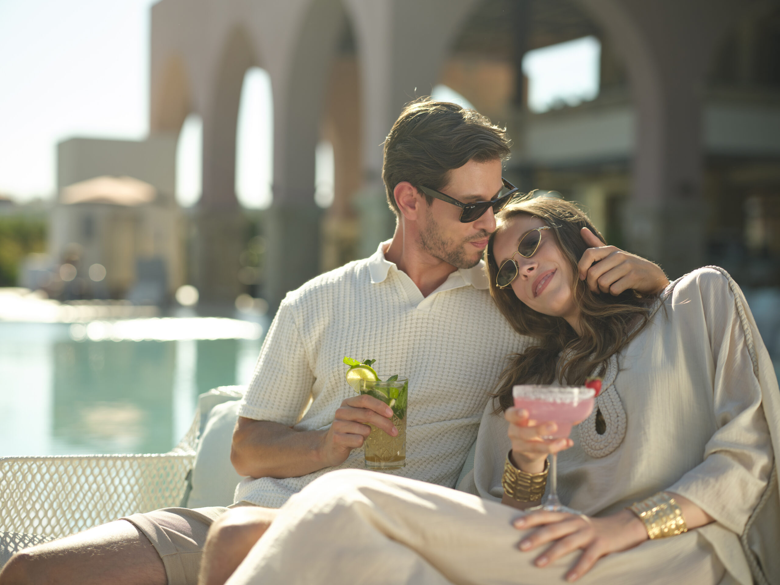 couple enjoy the silence at the pool with a cocktail