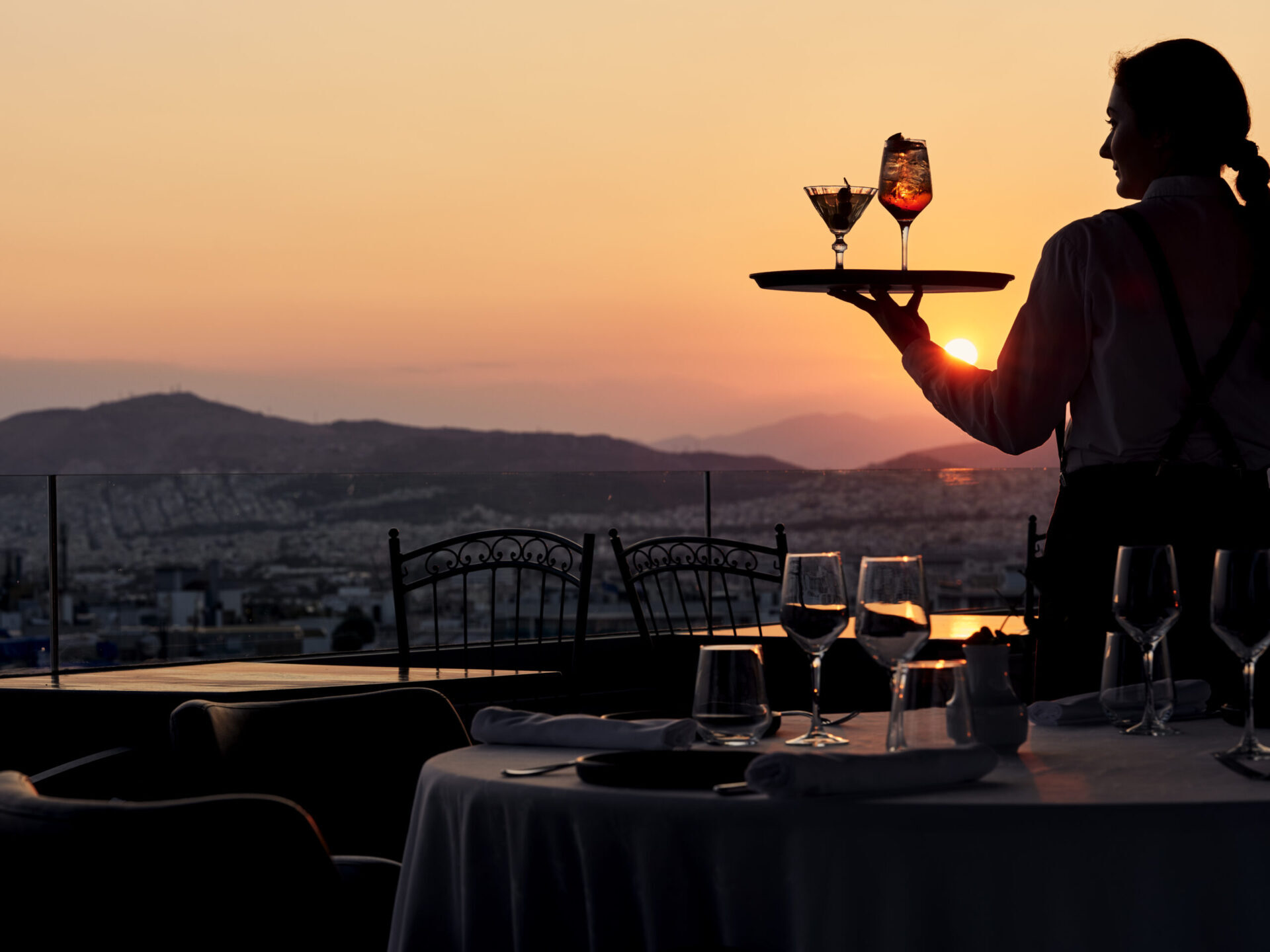 Sunset drinks at the rooftop of Titania Hotel Athens, made for short stays in Athens and more.