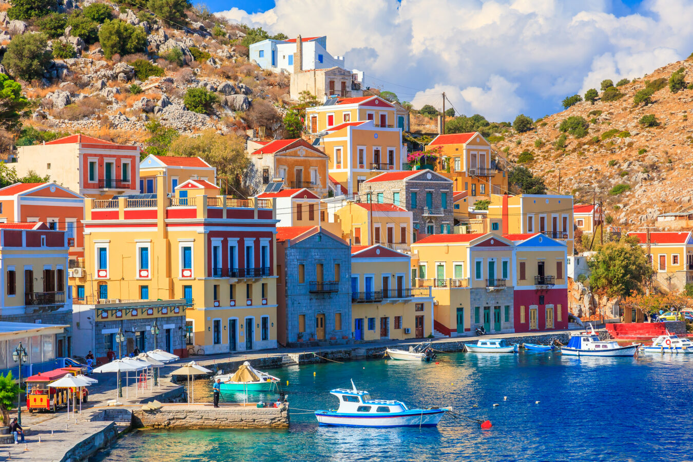 The colourful and quaint harbour of Symi island, one of the top 5 excursions to do in Rhodes.
