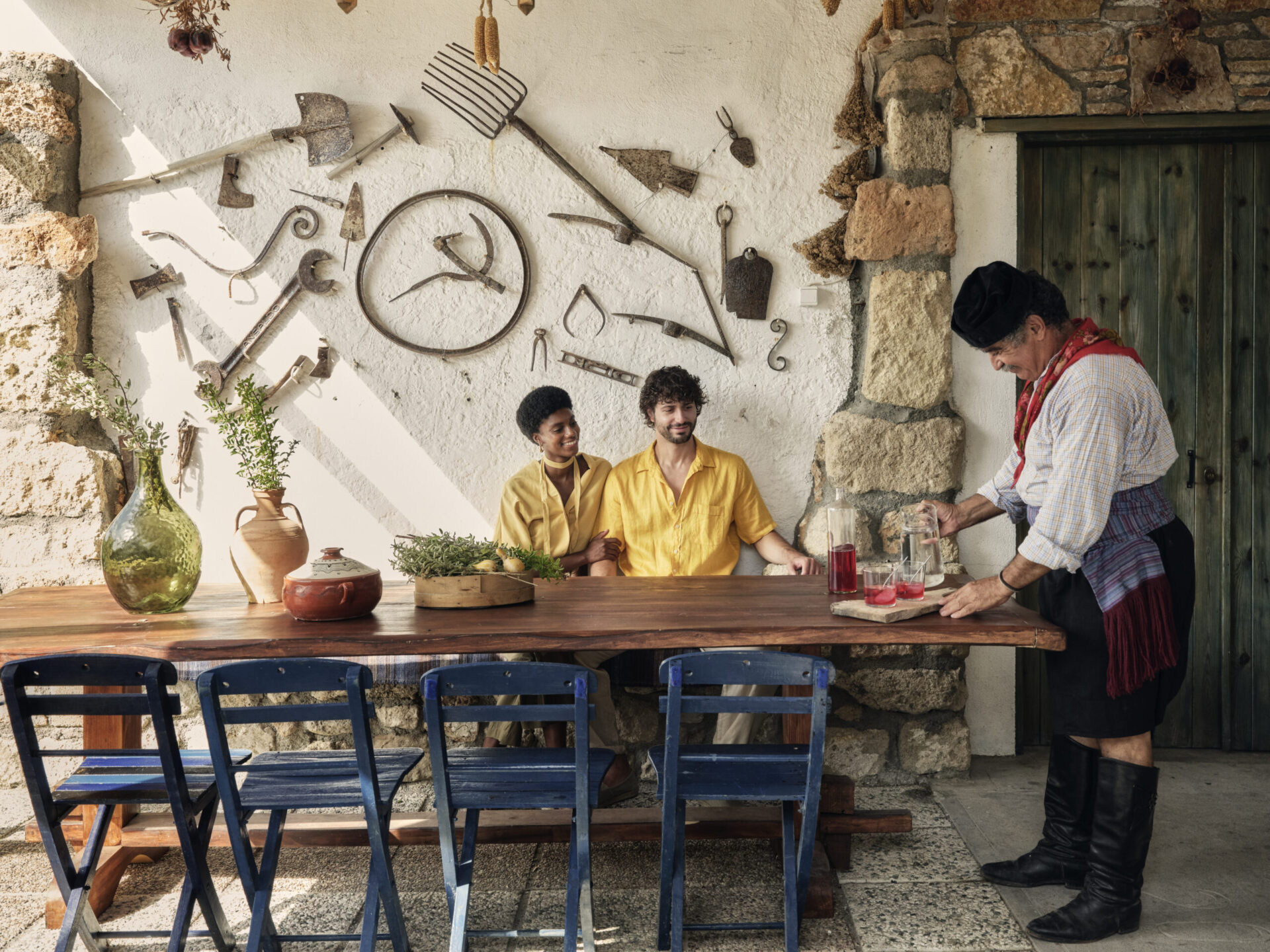 Couple being served by a local, as part of a cooking class, one of the top Autumn excursions in Rhodes.
